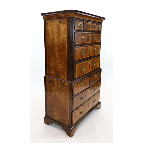 267 - A George II featherbanded walnut chest on chest, with moulded cornice, three short and three graduat... 