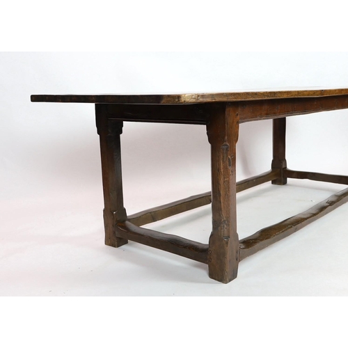 269 - A late 17th / 18th century oak and elm refectory table, with triple planked top, on octagonal legs w... 