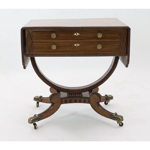 277 - Y Y A Regency mahogany drop leaf work table, with beaded rectangular top, scroll carved folding brac... 