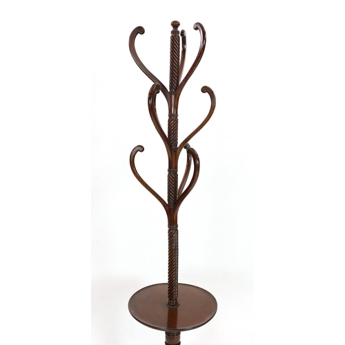 282 - A Regency mahogany hat stand, with central spiral twist column and nine scrolling arms over circular... 