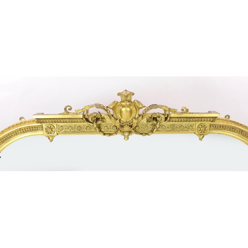 284 - A Victorian giltwood and gesso overmantel mirror, of arched form with foliate scroll crest and beade... 