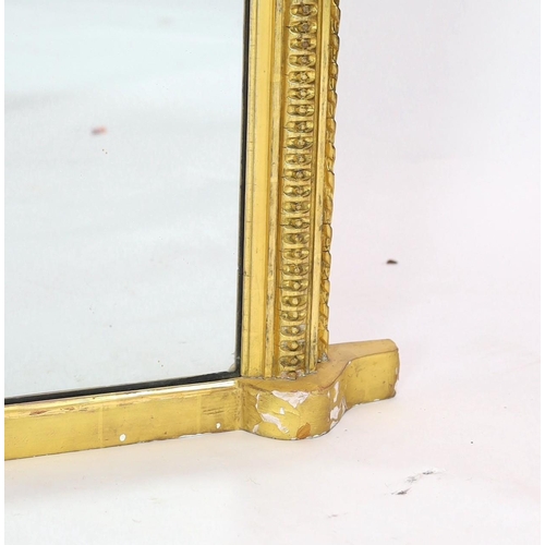 284 - A Victorian giltwood and gesso overmantel mirror, of arched form with foliate scroll crest and beade... 