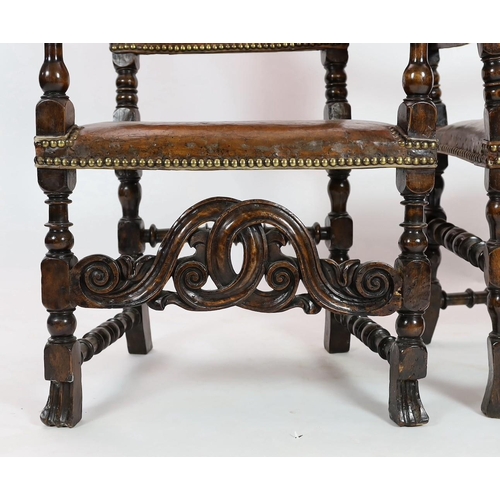 291 - A pair of late 17th century Spanish walnut and elm armchairs, with arched leather covered backs, mou... 