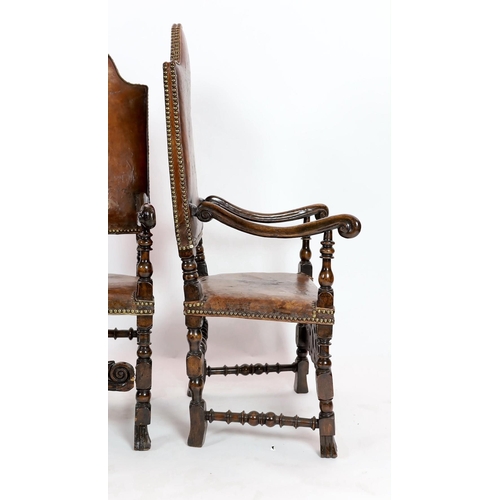 291 - A pair of late 17th century Spanish walnut and elm armchairs, with arched leather covered backs, mou... 