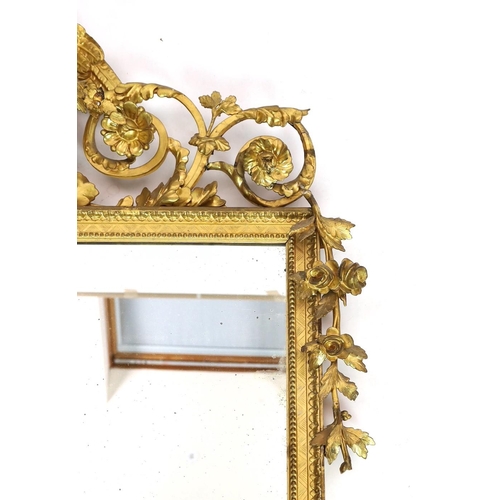 296 - A 19th century century carved giltwood wall mirror, with elaborate ornate eagle and flowering swag s... 