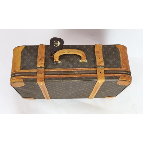 45 - A 1980/90s Louis Vuitton canvas monogram suitcase, with calf leather straps and brass hardware, inte... 