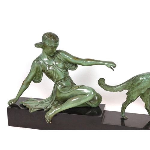 51 - Armand Godard. A French Art Deco patinated bronze and black marble group of a classical woman and bo... 