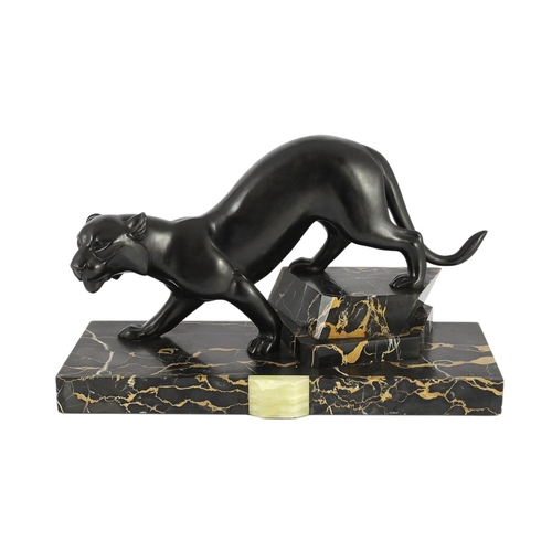 53 - Irene Rochard. A French Art Deco bronzed spelter and marble model of a black panther, standing upon ... 