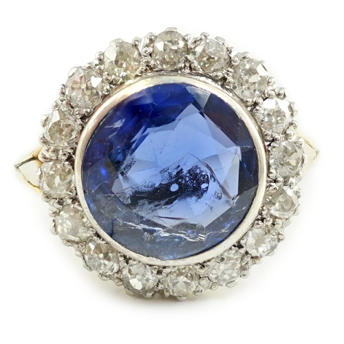 540 - A gold and single stone round cut sapphire set dress ring, with diamond set border, size L/M, gross ... 