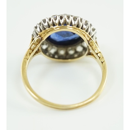 540 - A gold and single stone round cut sapphire set dress ring, with diamond set border, size L/M, gross ... 