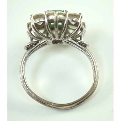 542 - A mid 20th century 18kt white gold, single stone emerald and round and baguette cut diamond cluster ... 