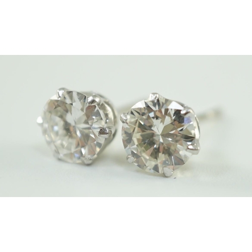 546 - A pair of white gold and solitaire diamond set ear studs, the stones diameter 6.2mm and 6.3mm, gross... 