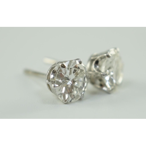 546 - A pair of white gold and solitaire diamond set ear studs, the stones diameter 6.2mm and 6.3mm, gross... 