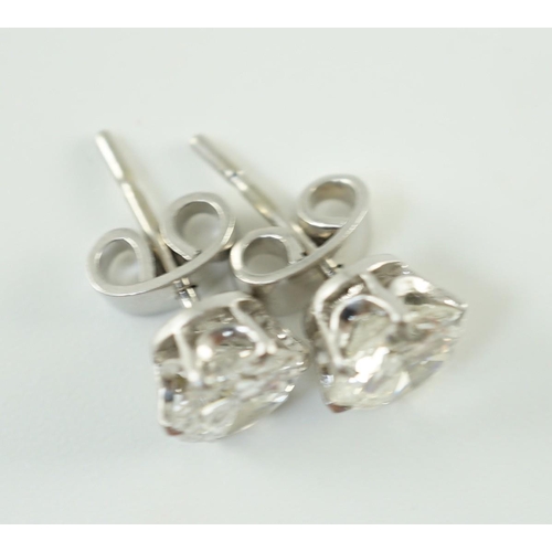 546 - A pair of white gold and solitaire diamond set ear studs, the stones diameter 6.2mm and 6.3mm, gross... 