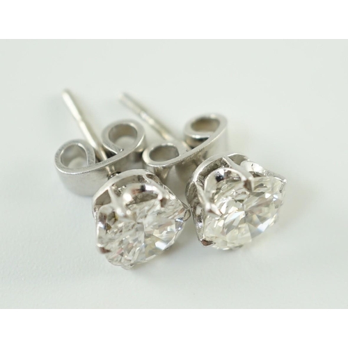 546 - A pair of white gold and solitaire diamond set ear studs, the stones diameter 6.2mm and 6.3mm, gross... 