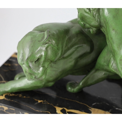 55 - Plagnet. A French Art Deco patinated spelter group of two panthers, standing upon a signed veined ma... 