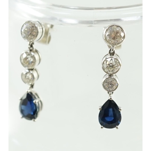 550 - A pair of 1980's platinum, single stone pear cut sapphire and graduated three stone collet set diamo... 