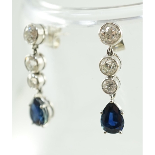 550 - A pair of 1980's platinum, single stone pear cut sapphire and graduated three stone collet set diamo... 