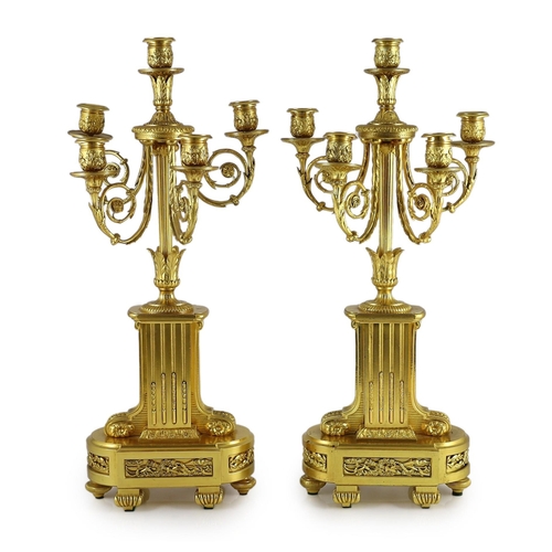 64 - A pair of 19th century French ormolu five light candelabra, with foliate scroll branches and stepped... 