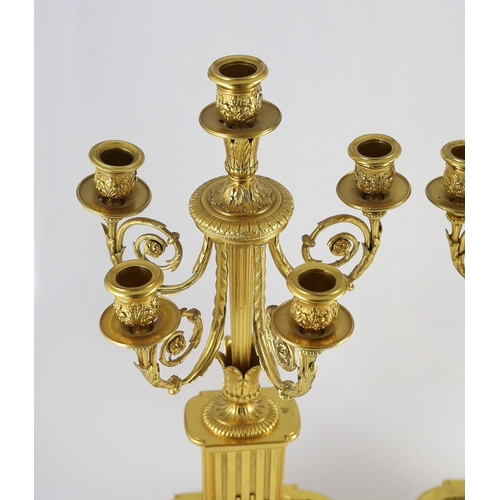 64 - A pair of 19th century French ormolu five light candelabra, with foliate scroll branches and stepped... 