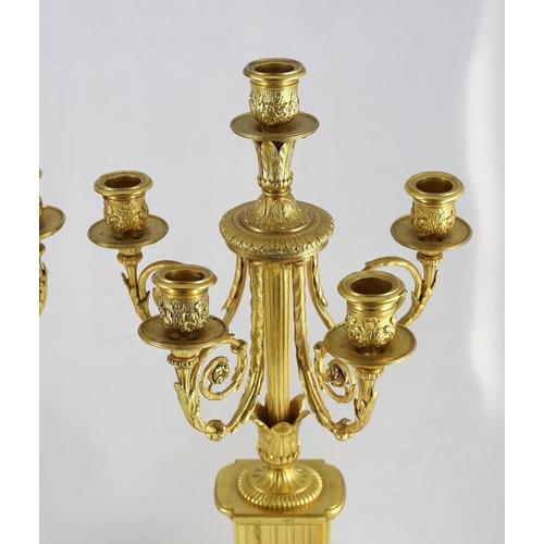 64 - A pair of 19th century French ormolu five light candelabra, with foliate scroll branches and stepped... 