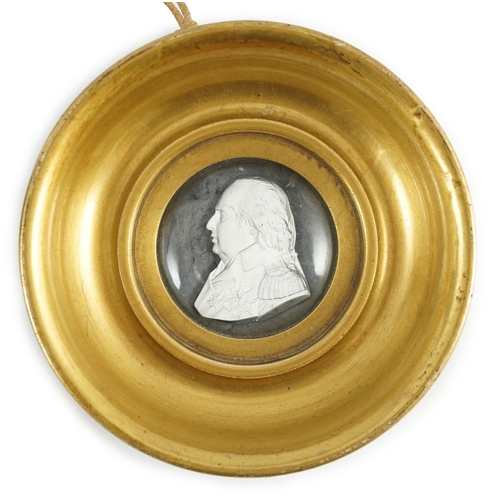 77 - A Louis XVIII glass sulphide portrait plaque, in a gilded porcelain frame, c.1820, the cristallo-cer... 