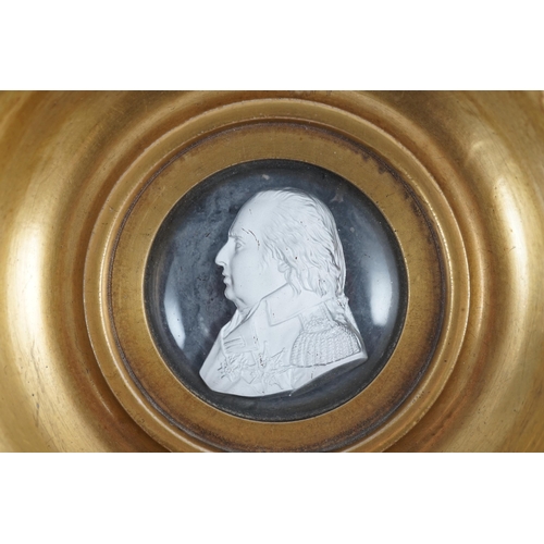 77 - A Louis XVIII glass sulphide portrait plaque, in a gilded porcelain frame, c.1820, the cristallo-cer... 