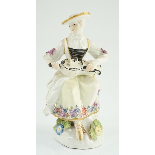 79 - A Meissen porcelain figure of a woman playing the hurdy gurdy, mid 18th century, possibly modelled b... 