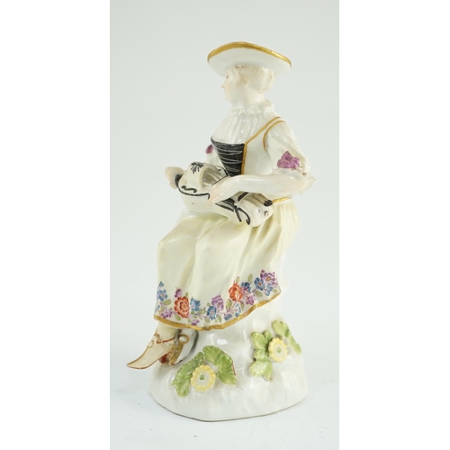 79 - A Meissen porcelain figure of a woman playing the hurdy gurdy, mid 18th century, possibly modelled b... 