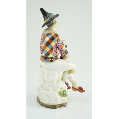 87 - A Meissen porcelain figure of a seated bagpiper, mid 18th century, modelled by J.J. Kandler, wearing... 