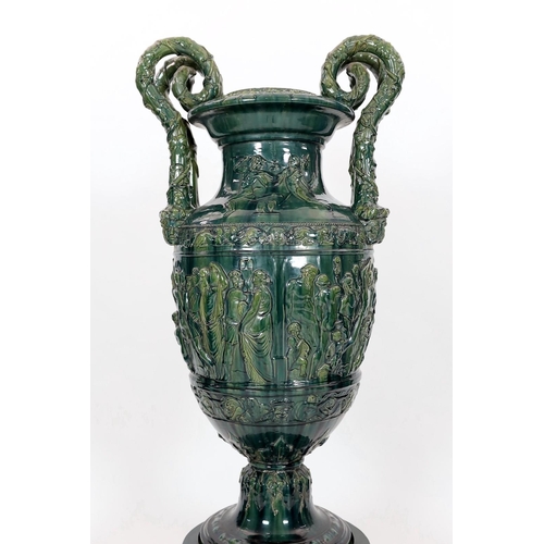 89 - A massive Continental majolica green glazed campana vase and associated stand, late 19th century, th... 