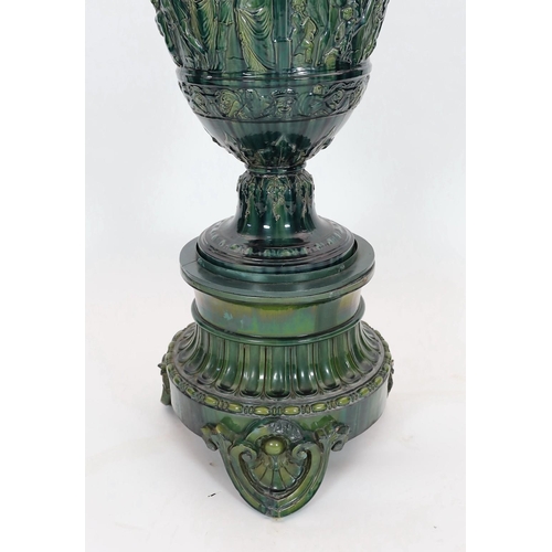 89 - A massive Continental majolica green glazed campana vase and associated stand, late 19th century, th... 