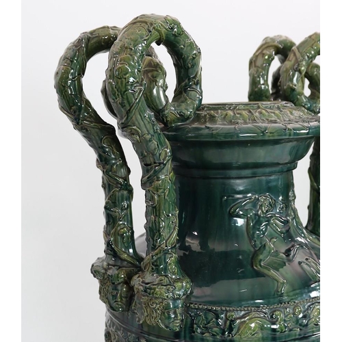 89 - A massive Continental majolica green glazed campana vase and associated stand, late 19th century, th... 