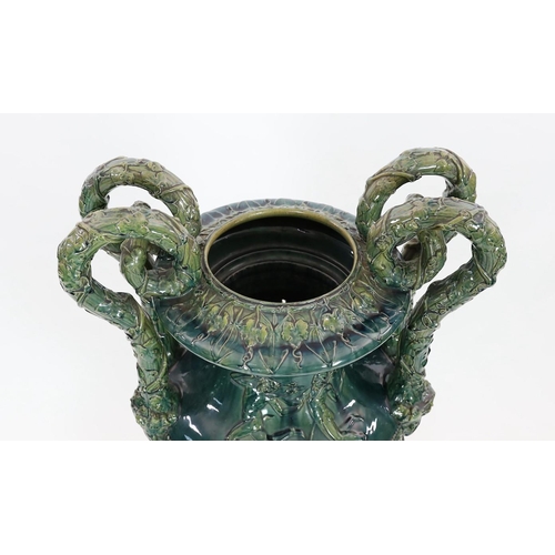 89 - A massive Continental majolica green glazed campana vase and associated stand, late 19th century, th... 