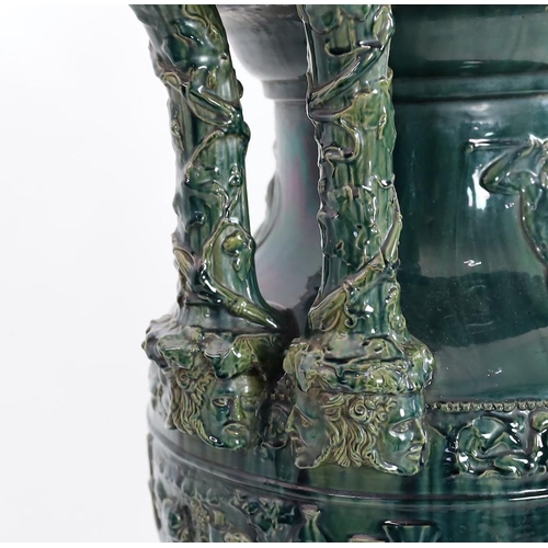 89 - A massive Continental majolica green glazed campana vase and associated stand, late 19th century, th... 