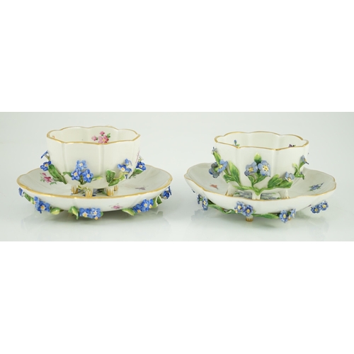 90 - Two Meissen flower encrusted cups and saucers, 19th century, typically painted with flower spray, in... 