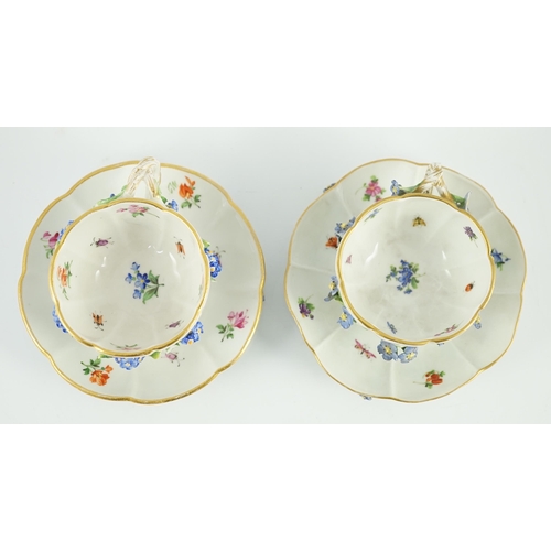 90 - Two Meissen flower encrusted cups and saucers, 19th century, typically painted with flower spray, in... 