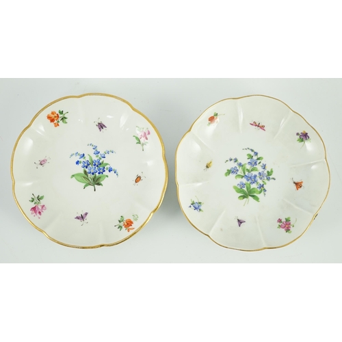 90 - Two Meissen flower encrusted cups and saucers, 19th century, typically painted with flower spray, in... 