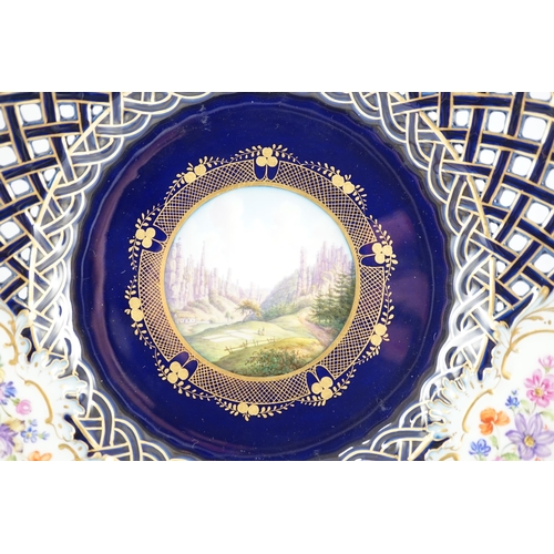 91 - A pair of Meissen reticulated named view plates, 19th century, painted to the centre with named view... 