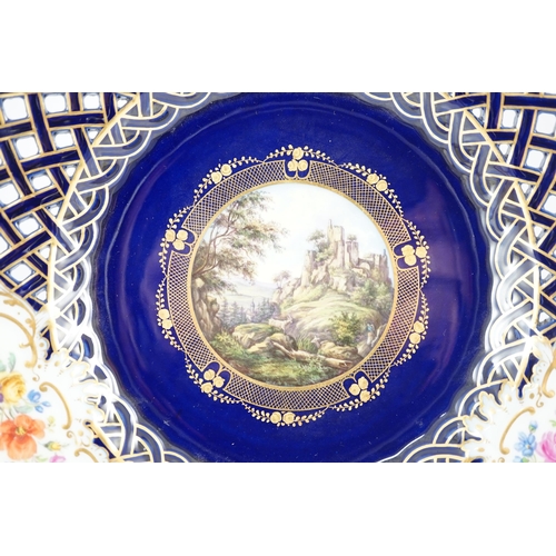 91 - A pair of Meissen reticulated named view plates, 19th century, painted to the centre with named view... 