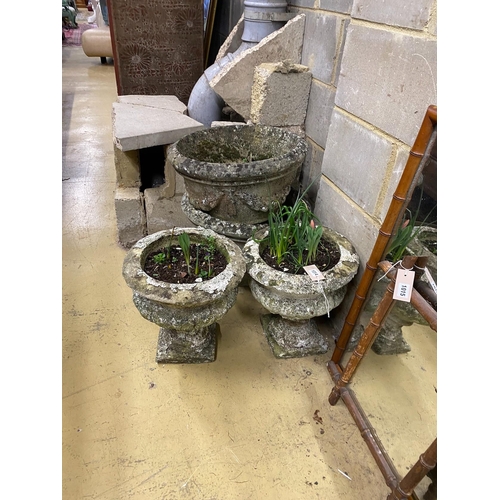 1014 - Four circular reconstituted stone garden planters, largest diameter 48cm, height 32cm