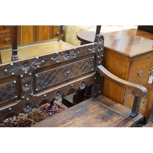 1124 - An 18th century style brass studded carved oak box seat settle, length 136cm, depth 40cm, height 93c... 