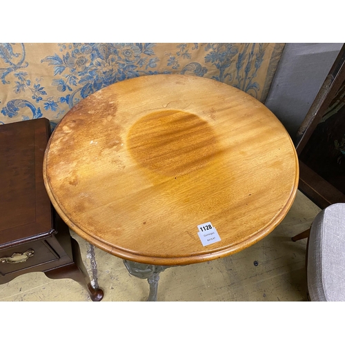 1128 - A painted cast iron Britannia pub table with circular mahogany top, diameter 68cm, height 76cm... 