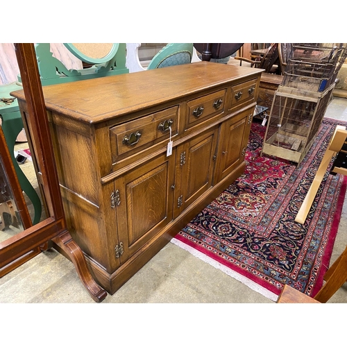 1168 - A reproduction 18th century style oak low dresser, fitted three drawers over three cupboards, length... 