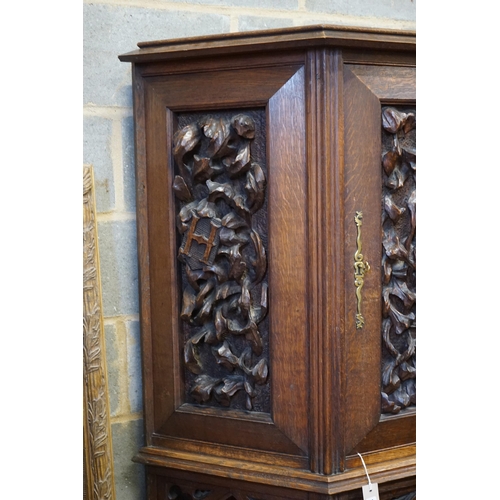 1178 - An early 20th century Gothic style carved oak side cabinet, width 118cm, depth 36cm, height 176cm... 