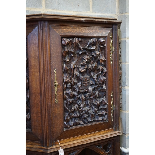 1178 - An early 20th century Gothic style carved oak side cabinet, width 118cm, depth 36cm, height 176cm... 