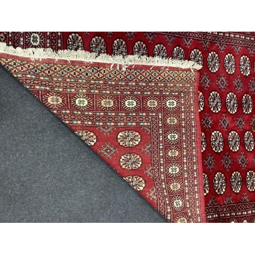 1190 - A Bokhara red ground rug, 246 x 152cm