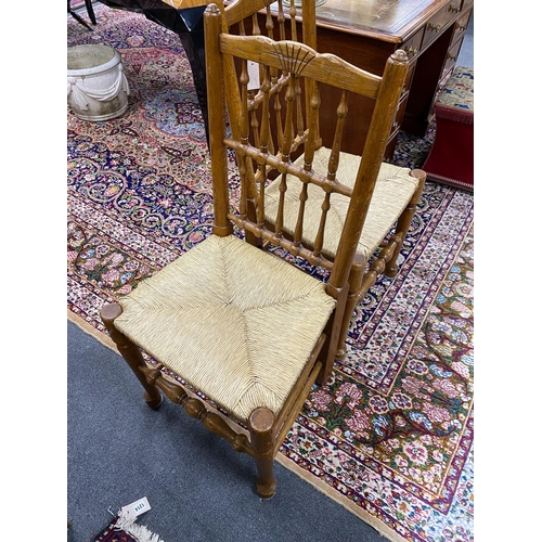 1210 - A set of eight Lancashire style oak spindle back rush seat dining chairs