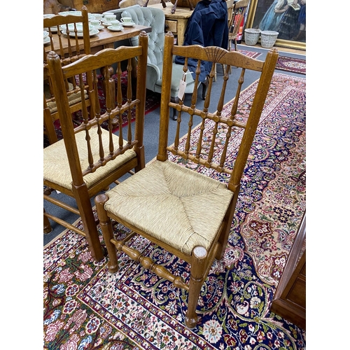 1210 - A set of eight Lancashire style oak spindle back rush seat dining chairs