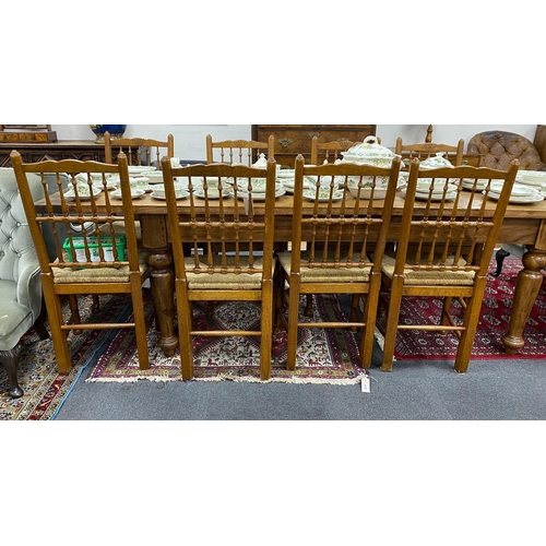 1210 - A set of eight Lancashire style oak spindle back rush seat dining chairs